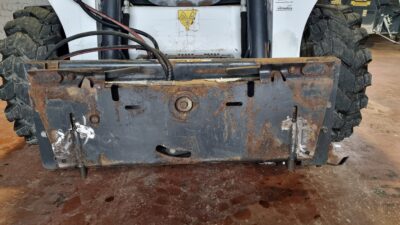 Bobcat Bucket gate mechanism